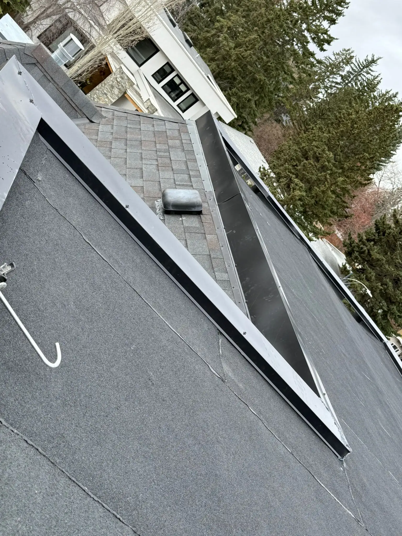 Custom aluminum parapet flashing after an SBS flat roof installation in Calgary, AB