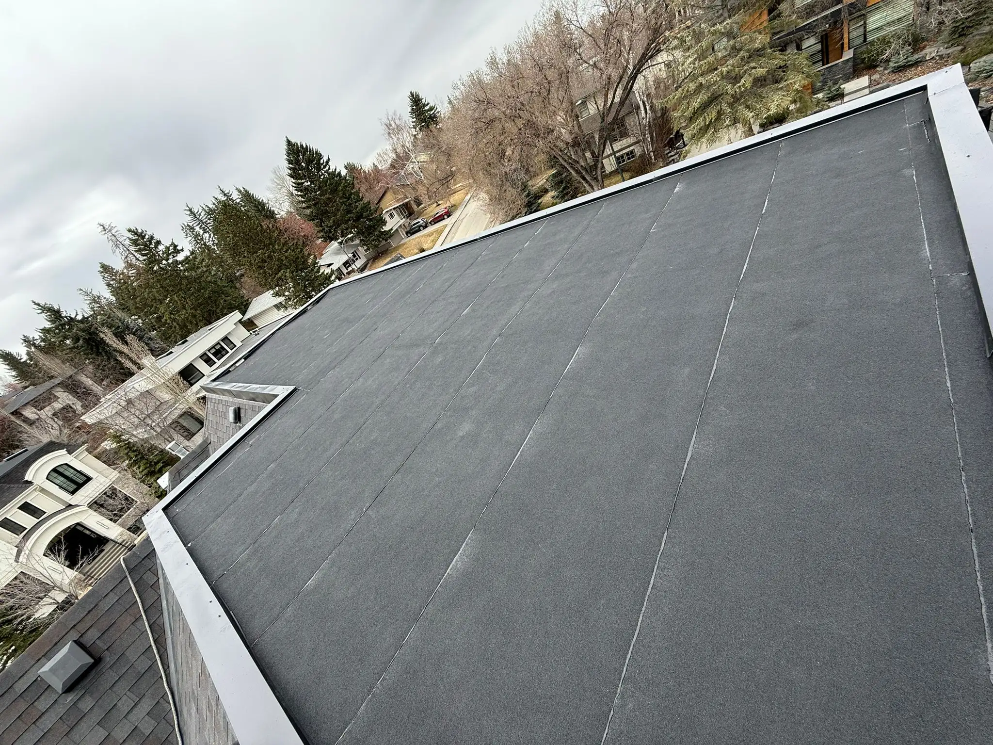 Finished two-ply SBS flat roof with parapet flashing on a Calgary home