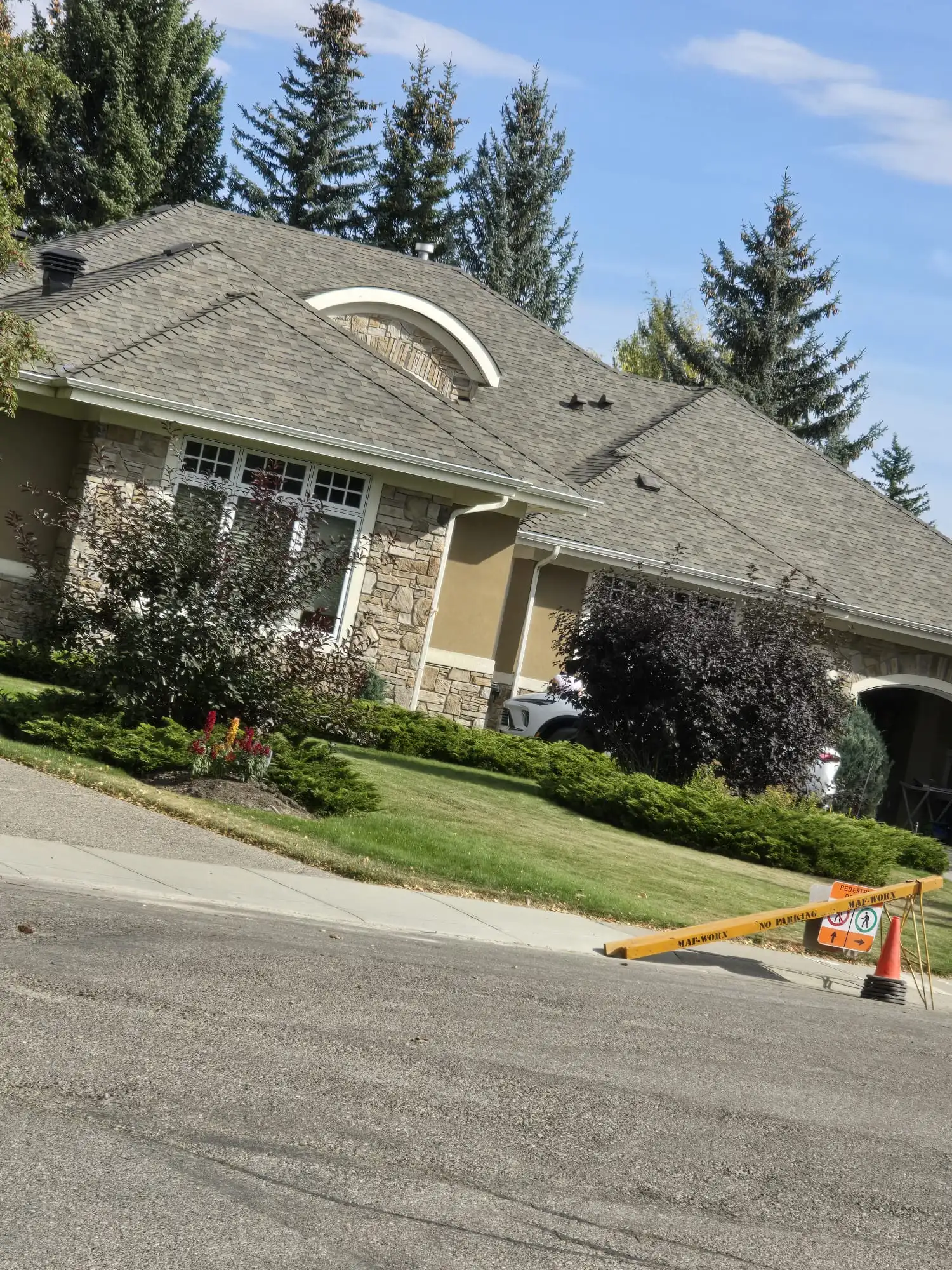 Ground view of a newly replaced asphalt shingle roof in Calgary, AB