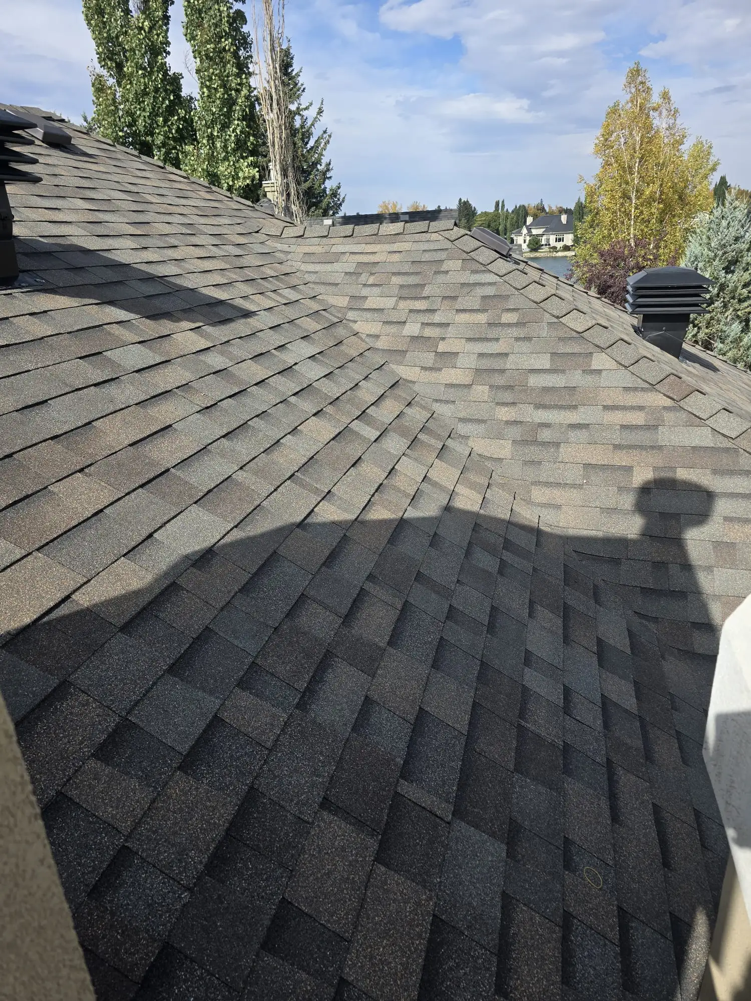 High-profile ridge cap detail on newly replaced shingles in Calgary, AB