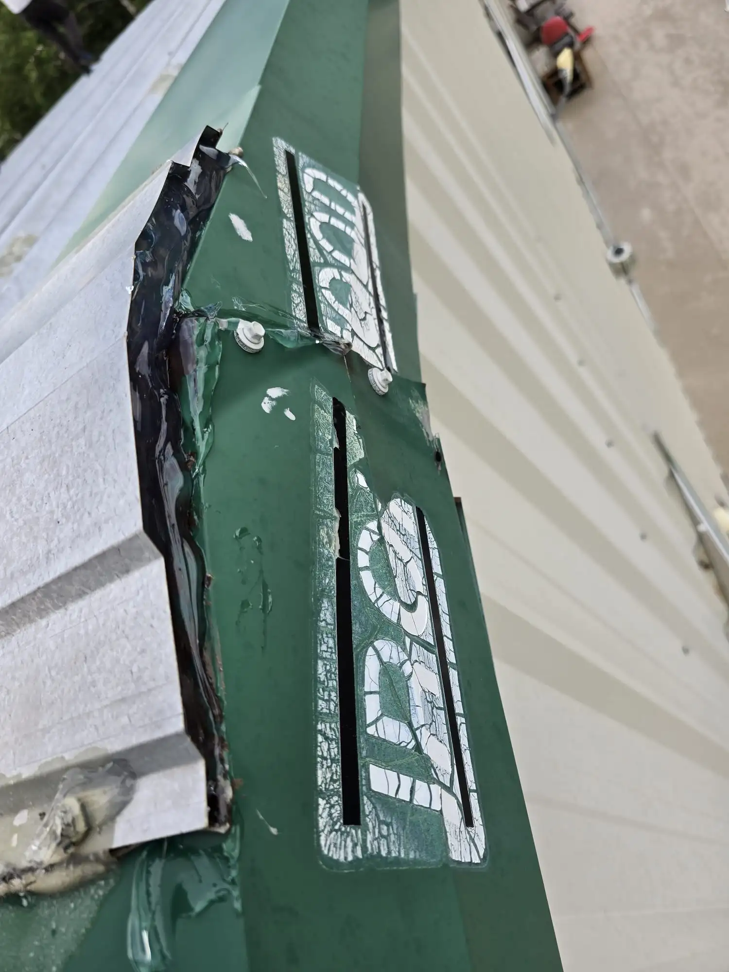 Damaged metal roof fascia flashing with failed sealant, found during a Calgary roof inspection