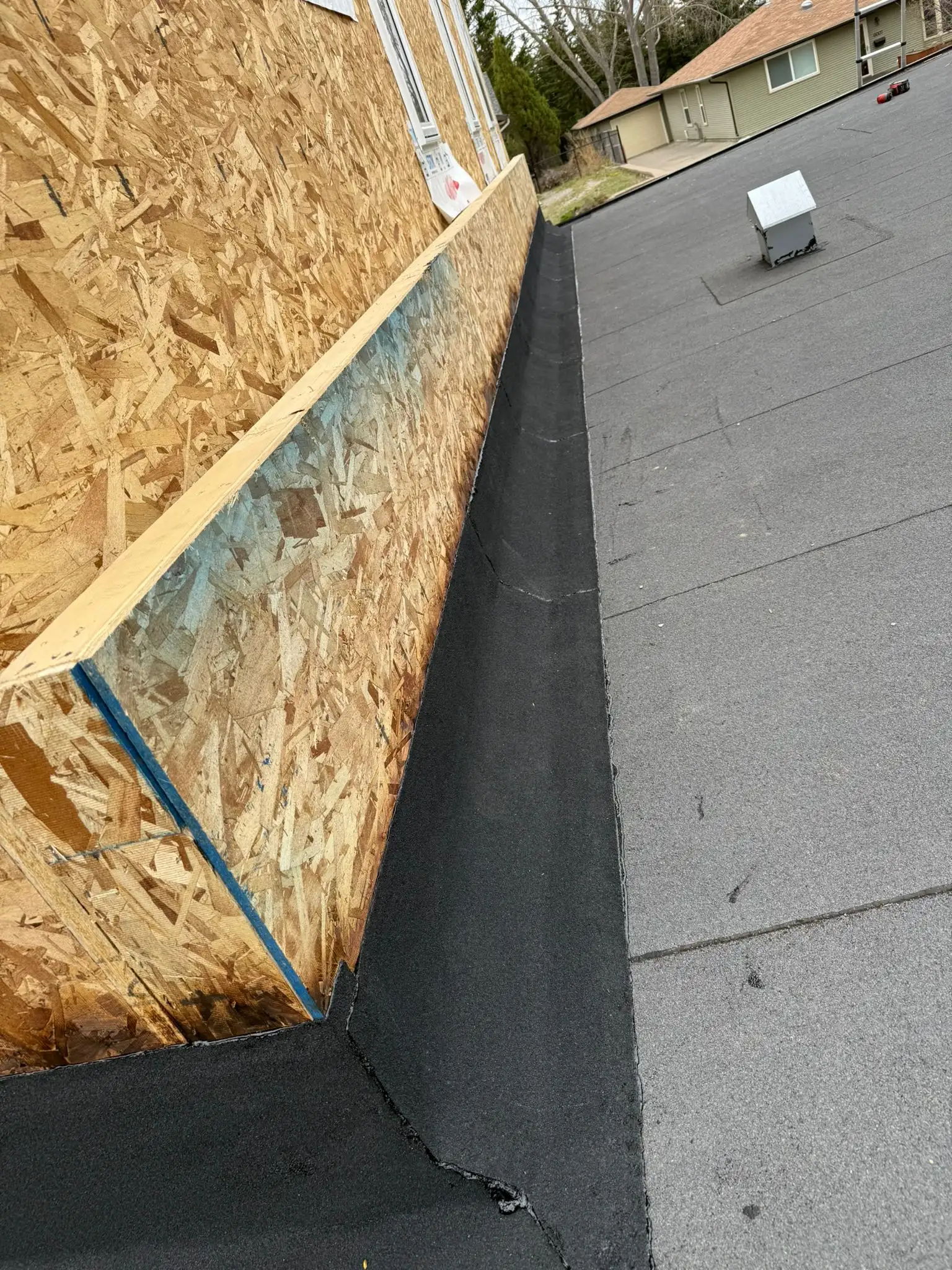 SBS membrane lapped up the wall of a house addition to code in Calgary
